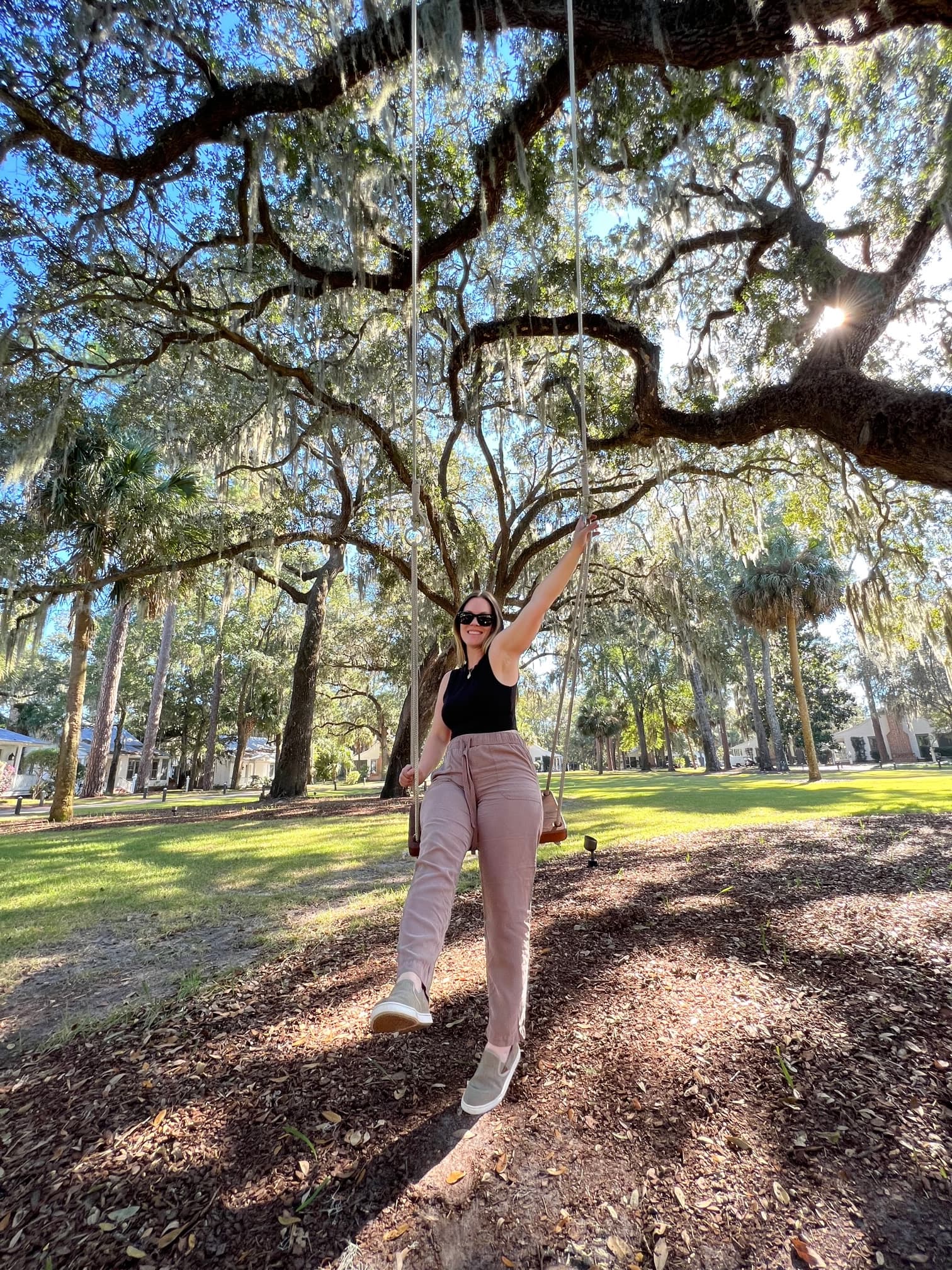 Travel advisor posing under tree