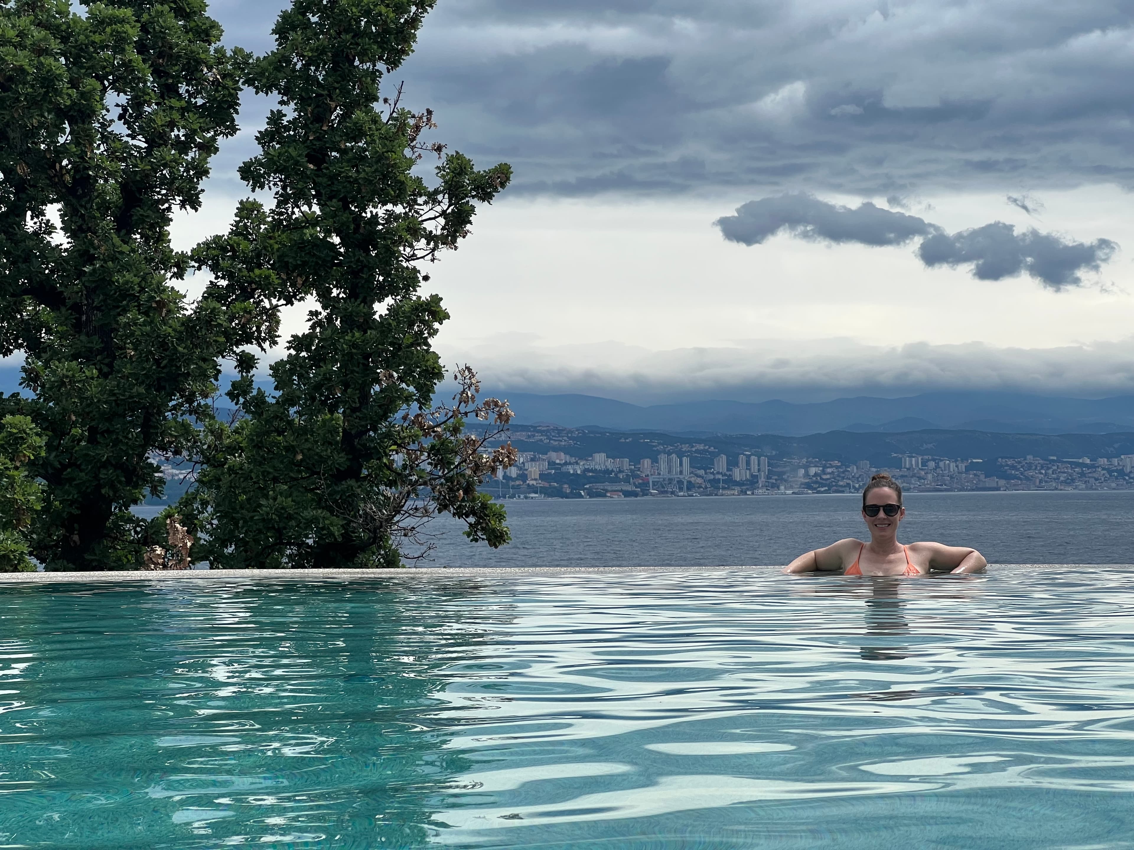 Travel advisor posing in a pool