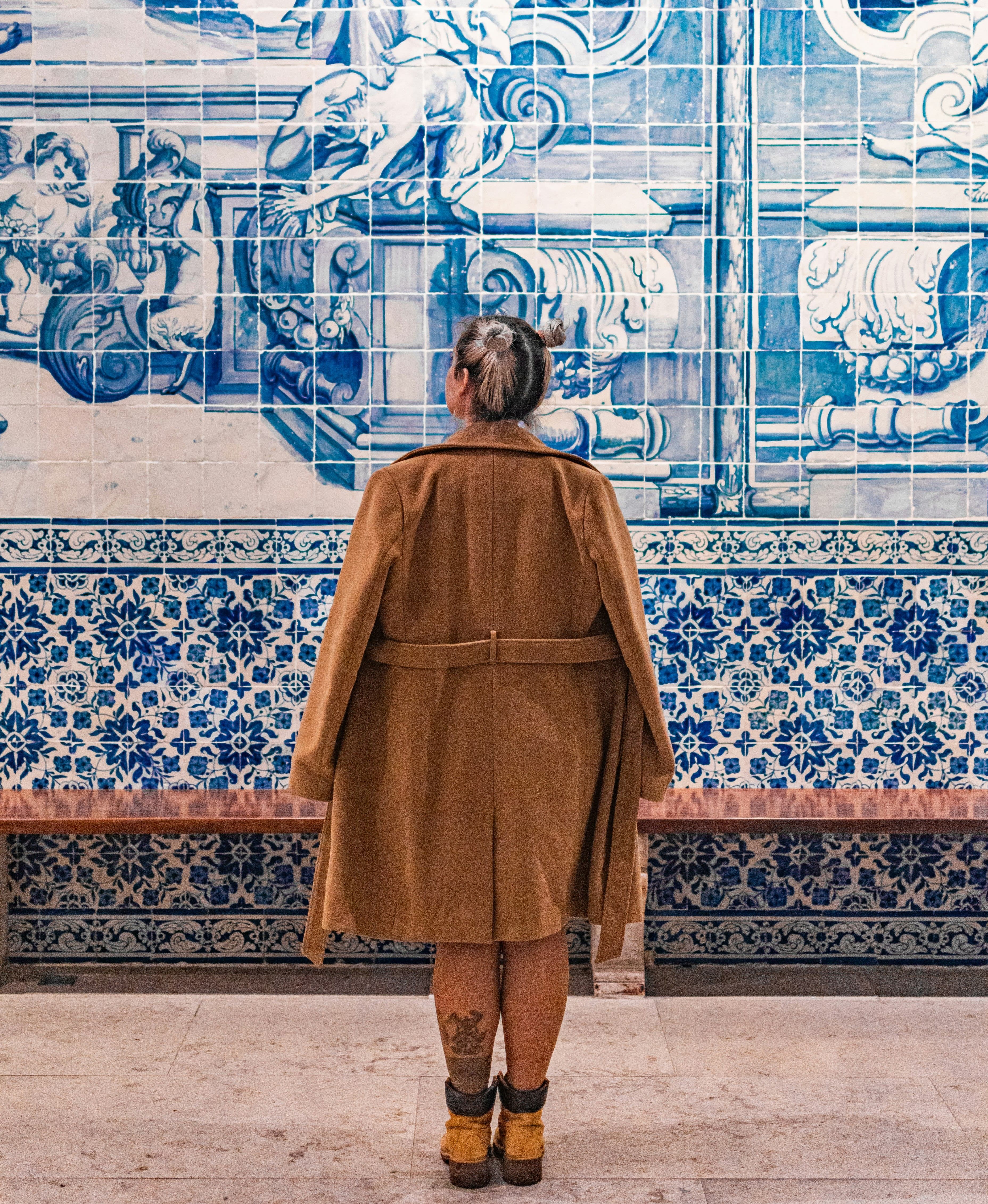 A view of the city of Porto, Portugal, with red rooftops, residential building, and a big, blue sky.