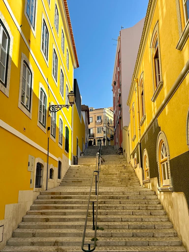 Stairs between yellow buildings.