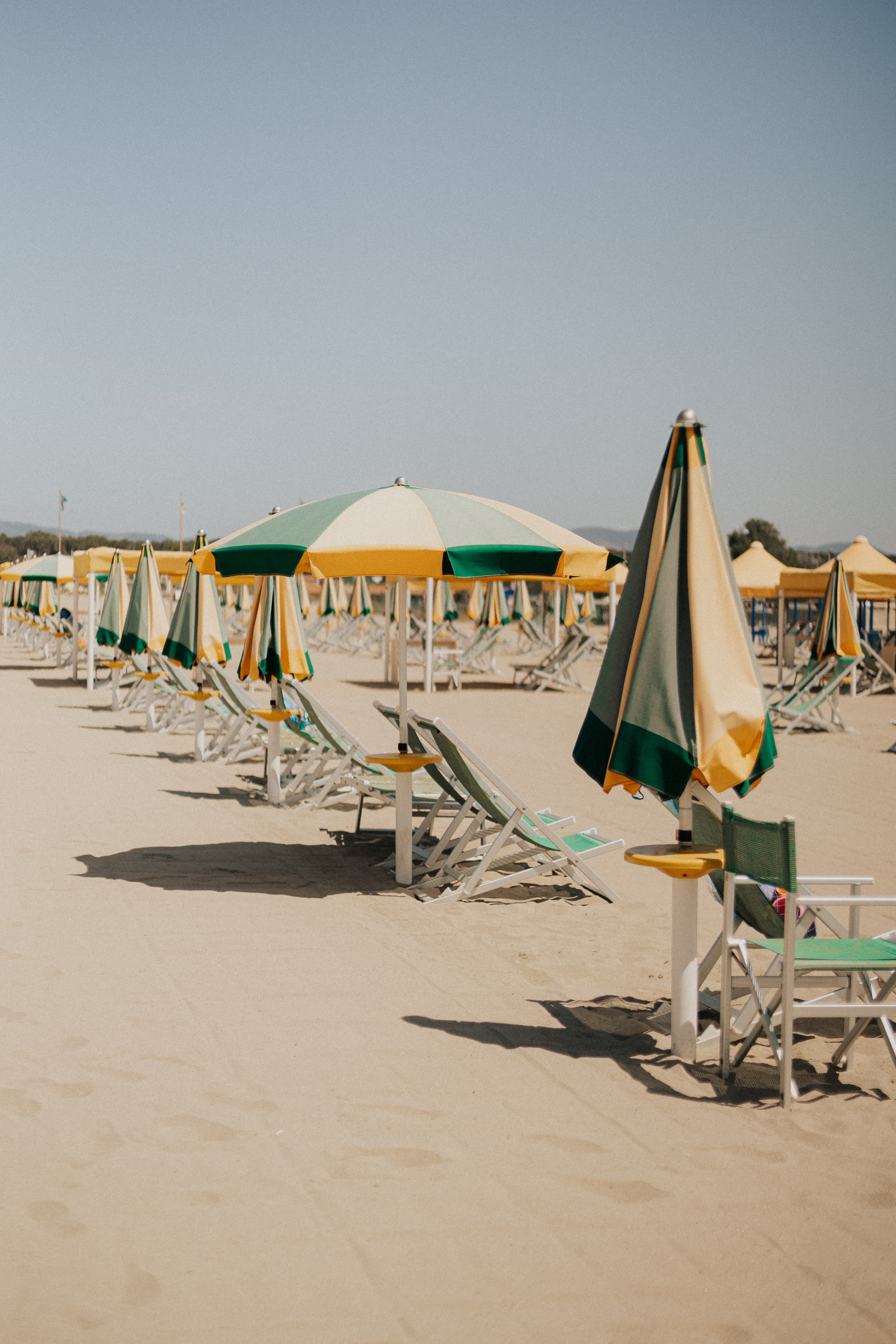 beach chairs on the sand during daytime