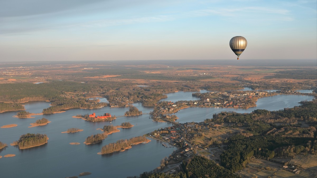 A hot air balloon flying over a body of water