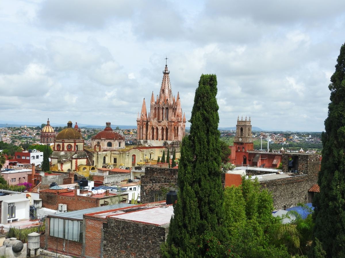 tall buildings and church with cloudy skies