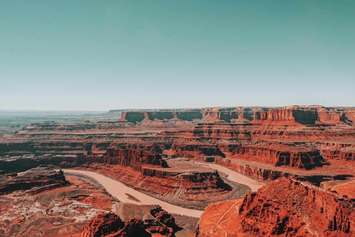 Canyon of red rocks on a cloudless day with blue sky in Utah.