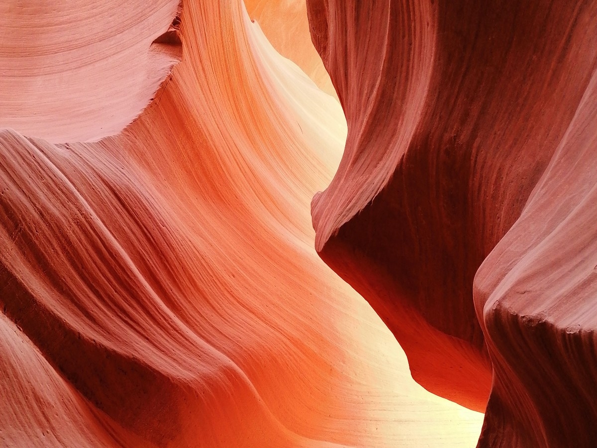 View from between narrow red rock canyons at Antelope Canyon, AZ.