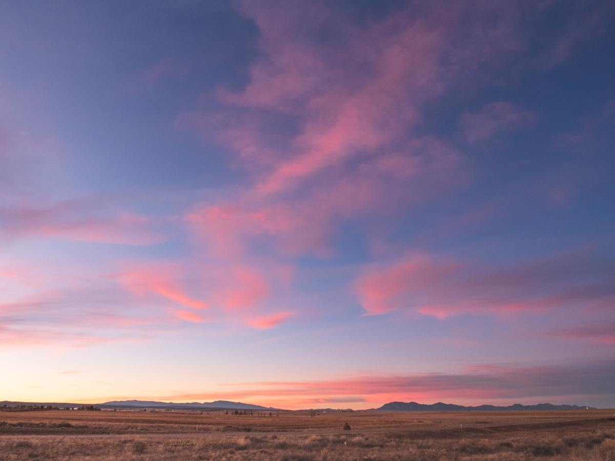 Sunset with pink clouds on desert valley in New Mexico.