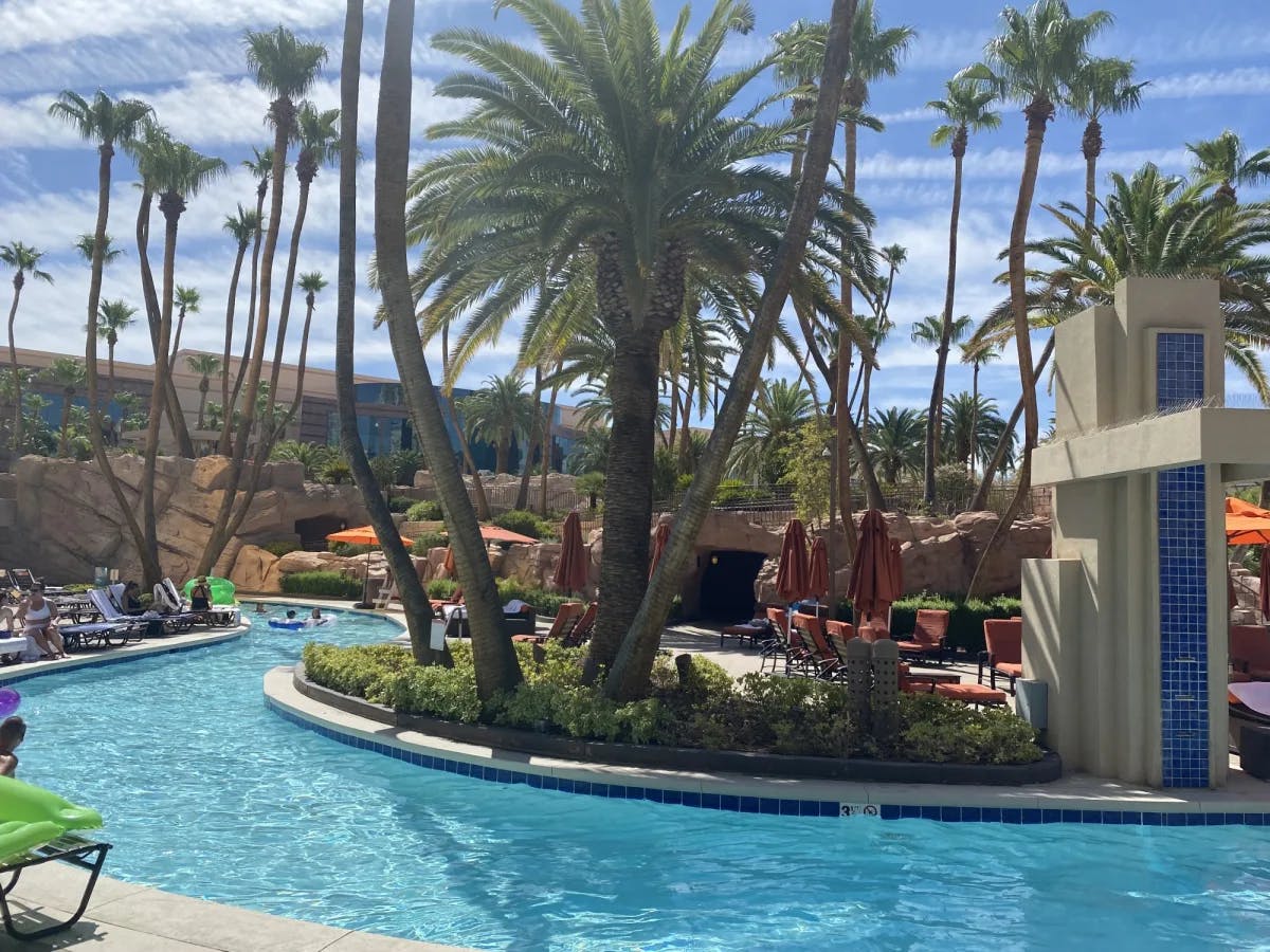 A resort with pool and palm trees. 