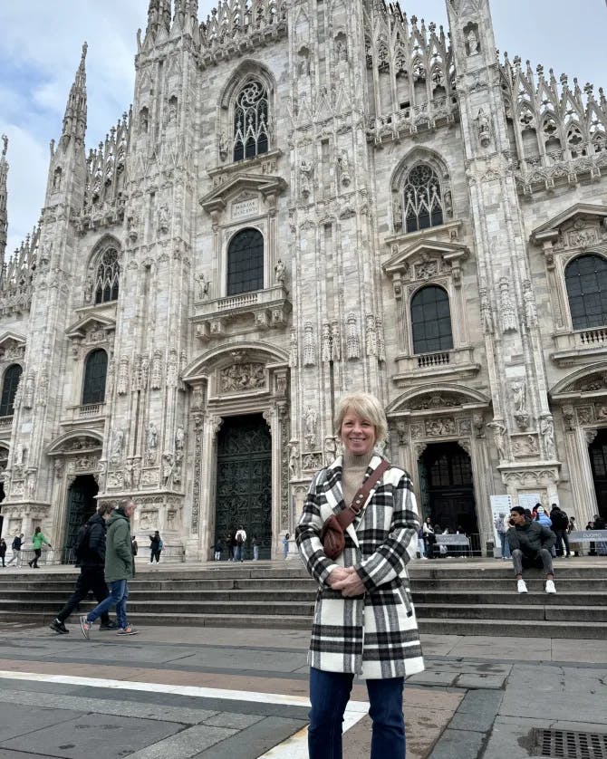 Advisor posing in front of a classic building in Milan, Italy. 