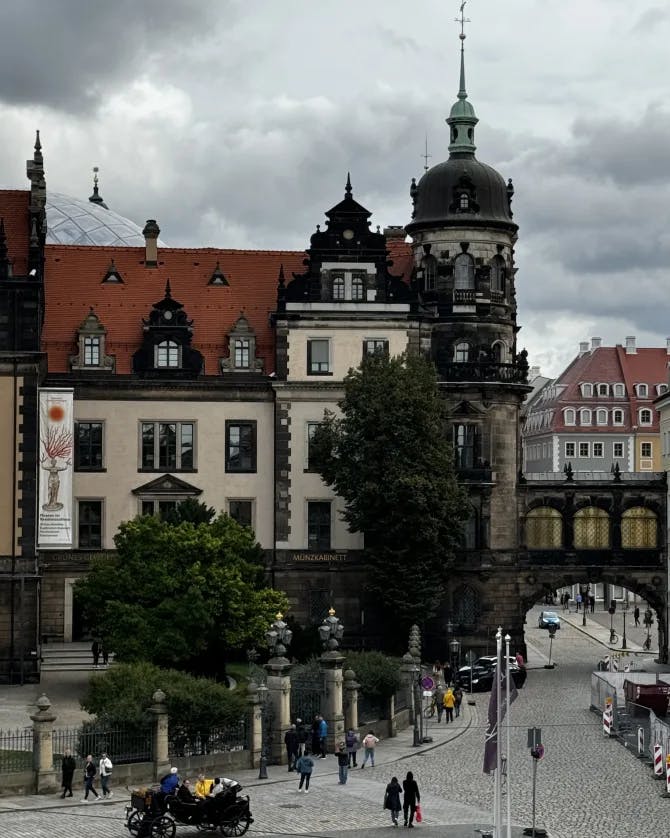 A bustling city street featuring a bridge and various buildings lining the sides.