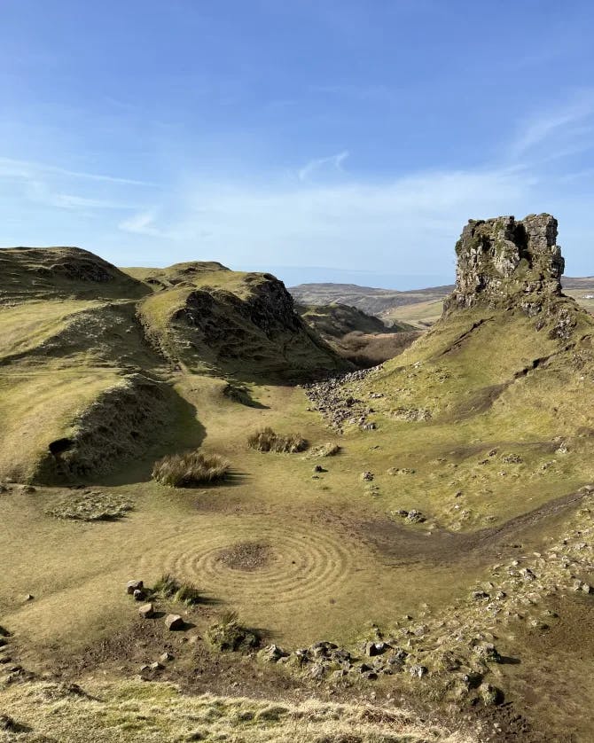 The Fairy Glen presents a charming miniature landscape with grassy, cone-shaped hills.