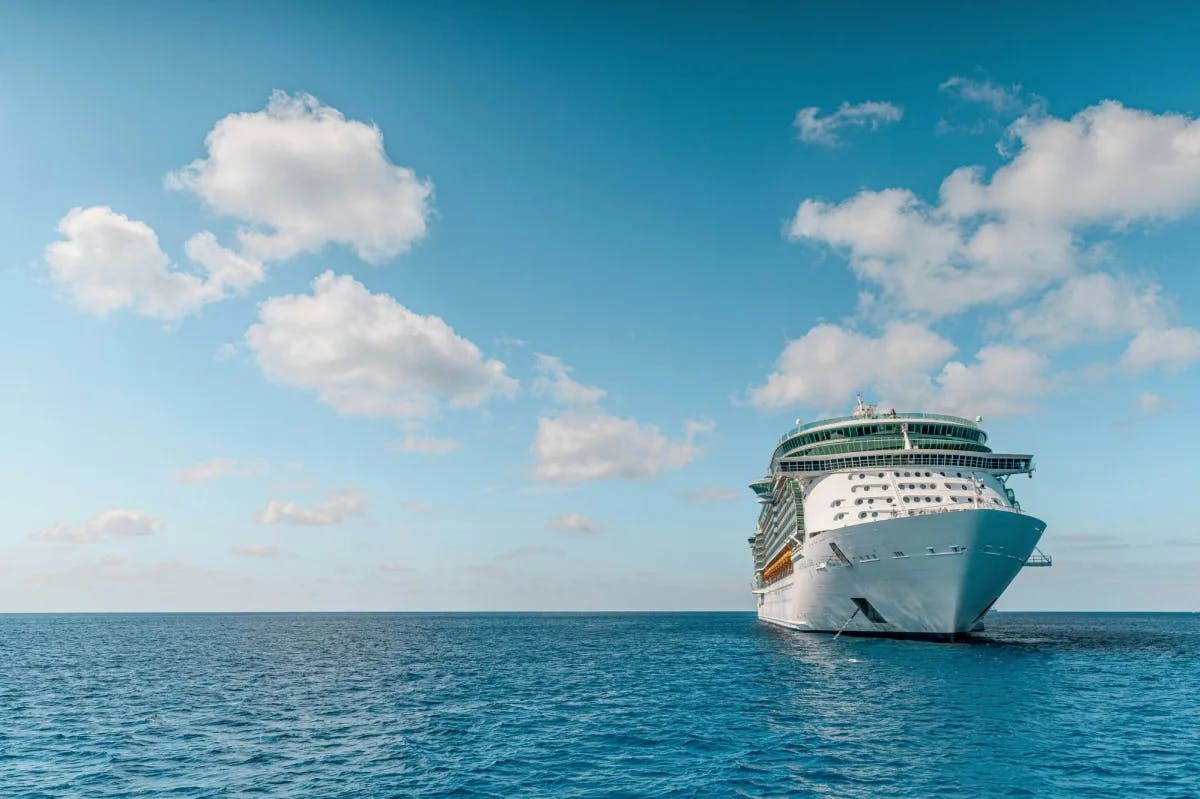 open ocean and blue sky with the bow of a large cruise ship