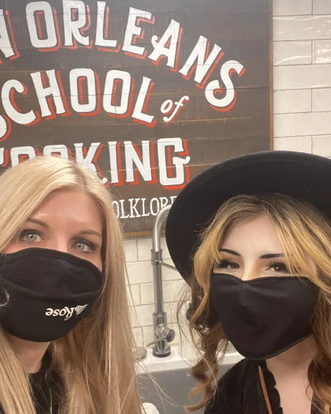 Two women posing in mask