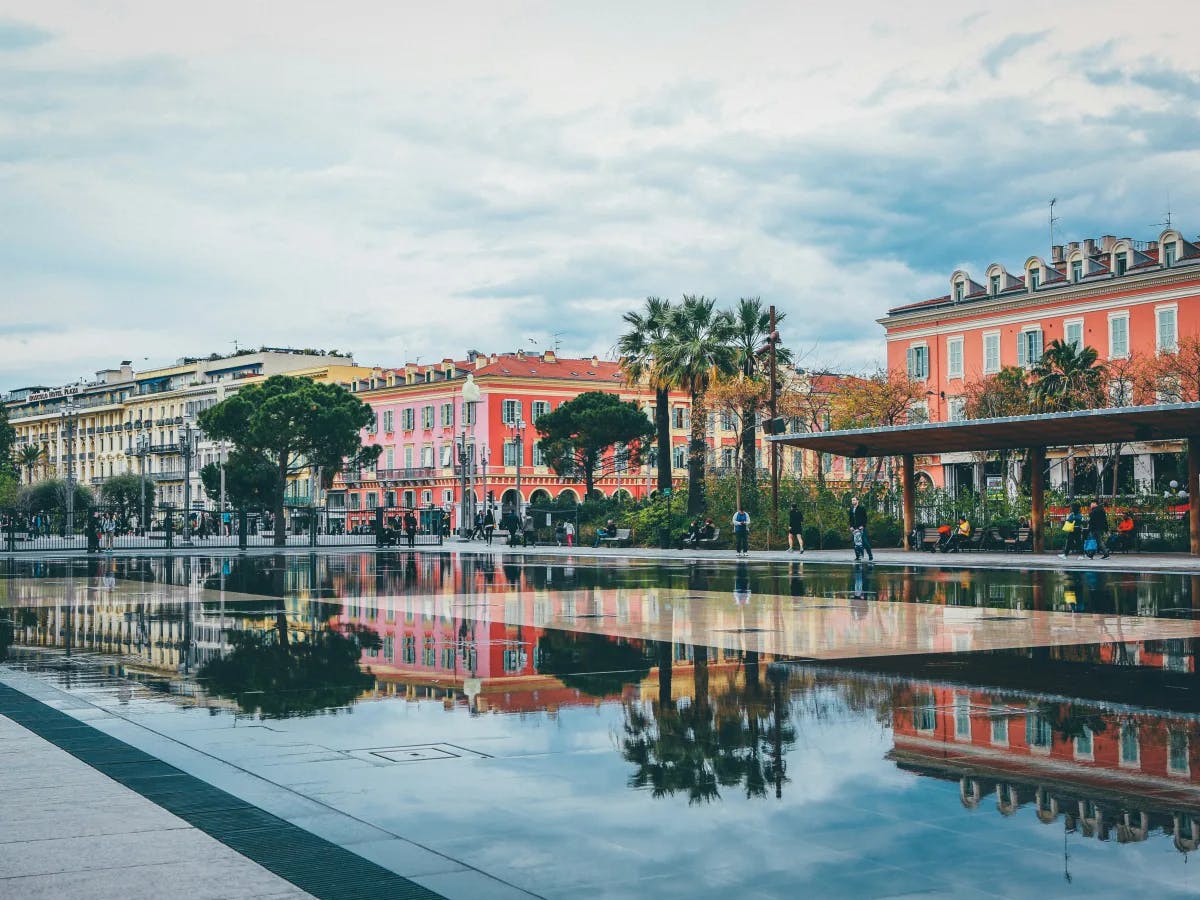 A vibrant urban canal scene with colorful buildings and boats, reflecting on the water to create a picturesque mirror effect.