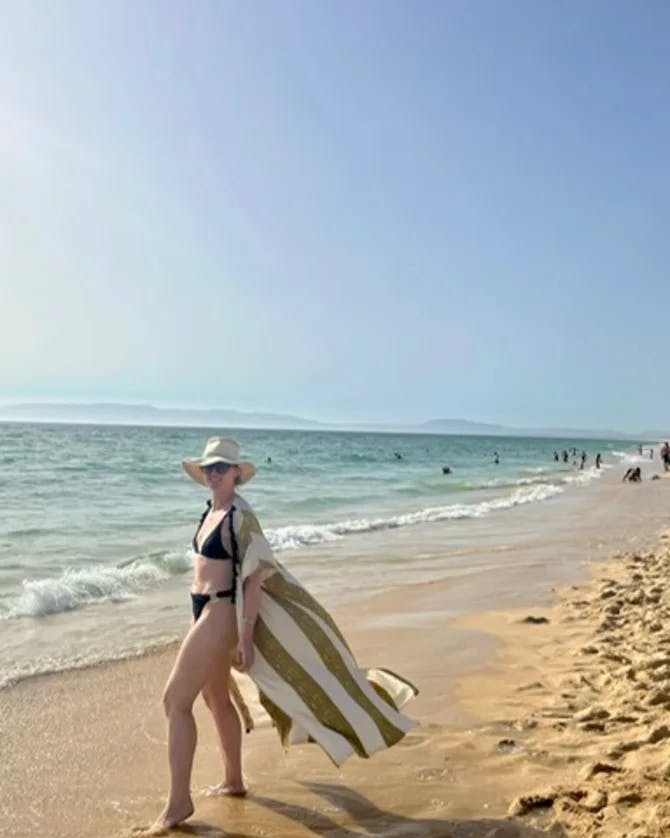 Travel advisor posing beside beach