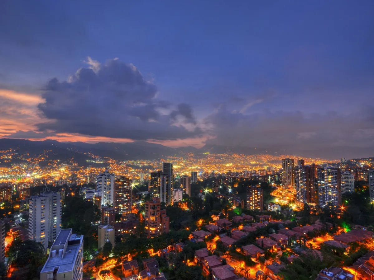 A panoramic cityscape at dusk, where the urban glow softly transitions from day to night.