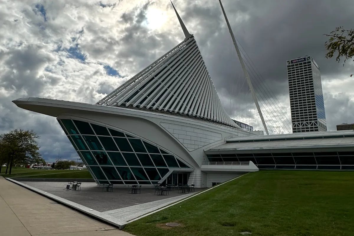 A picture of an art museum taken from outside during evening.