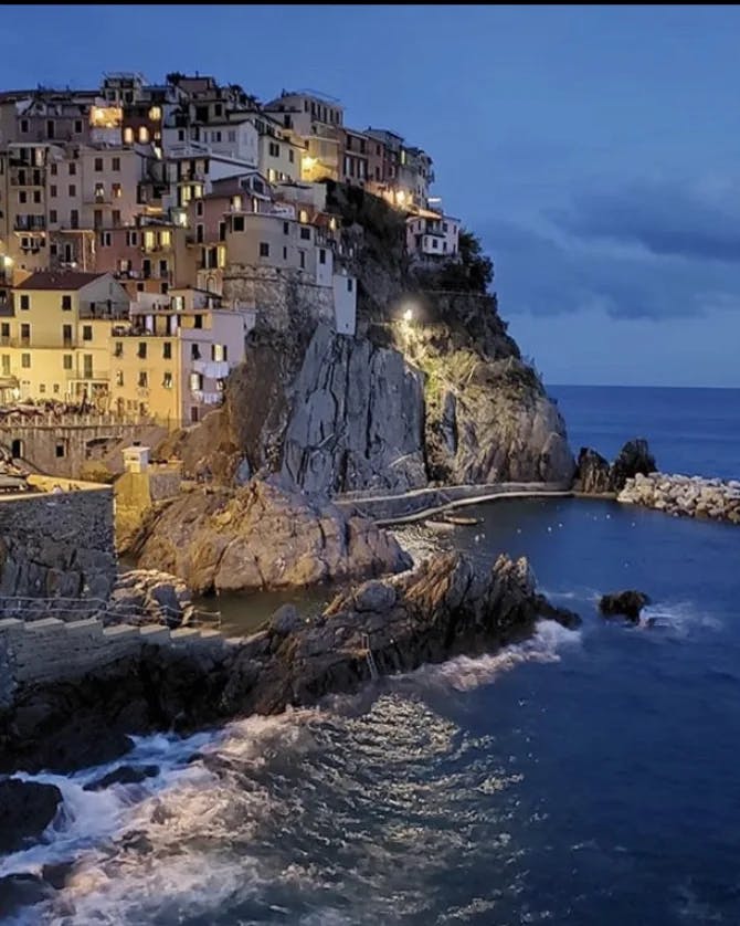 coastal cliffside island town lit up at night