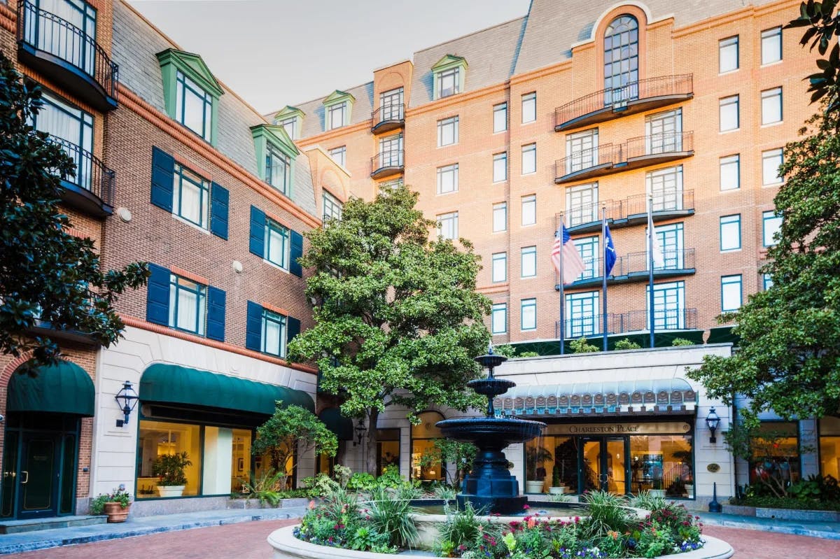 Facade of a red brick hotel from an outside courtyard