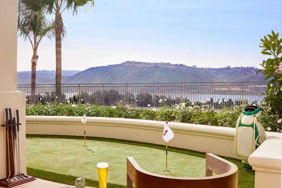 balcony with a mini putting green and mountains in the background