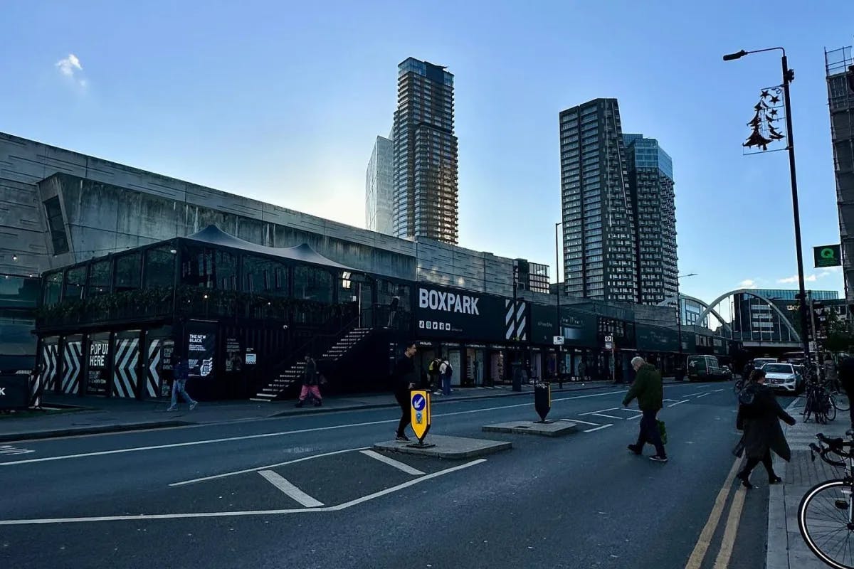 A street outside of an event space with view of two skyscraper buildings