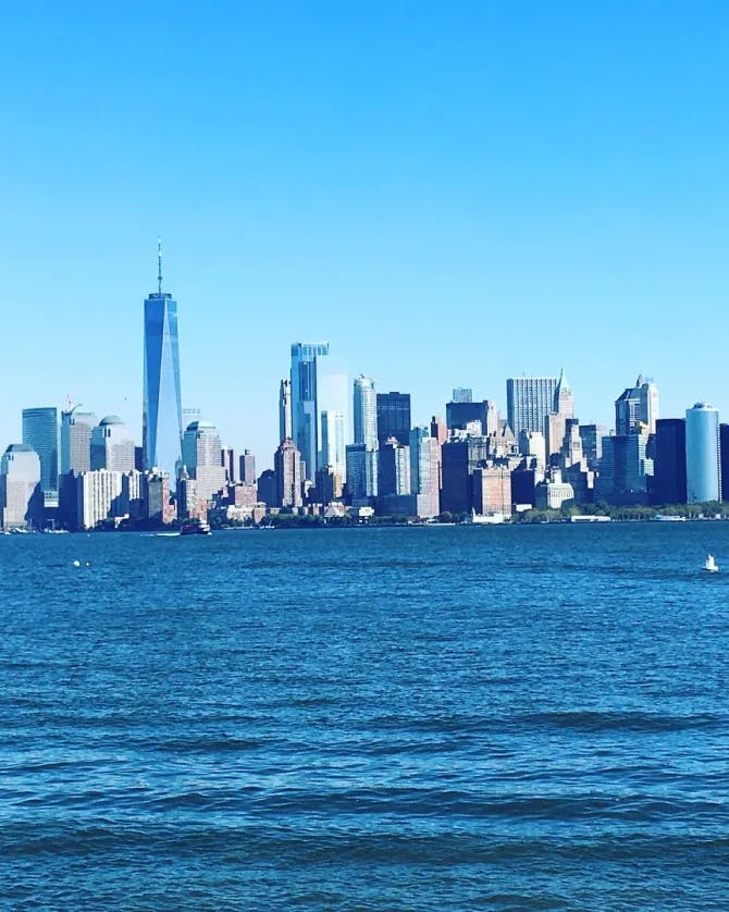 Skyscrapers over water and blue skies.