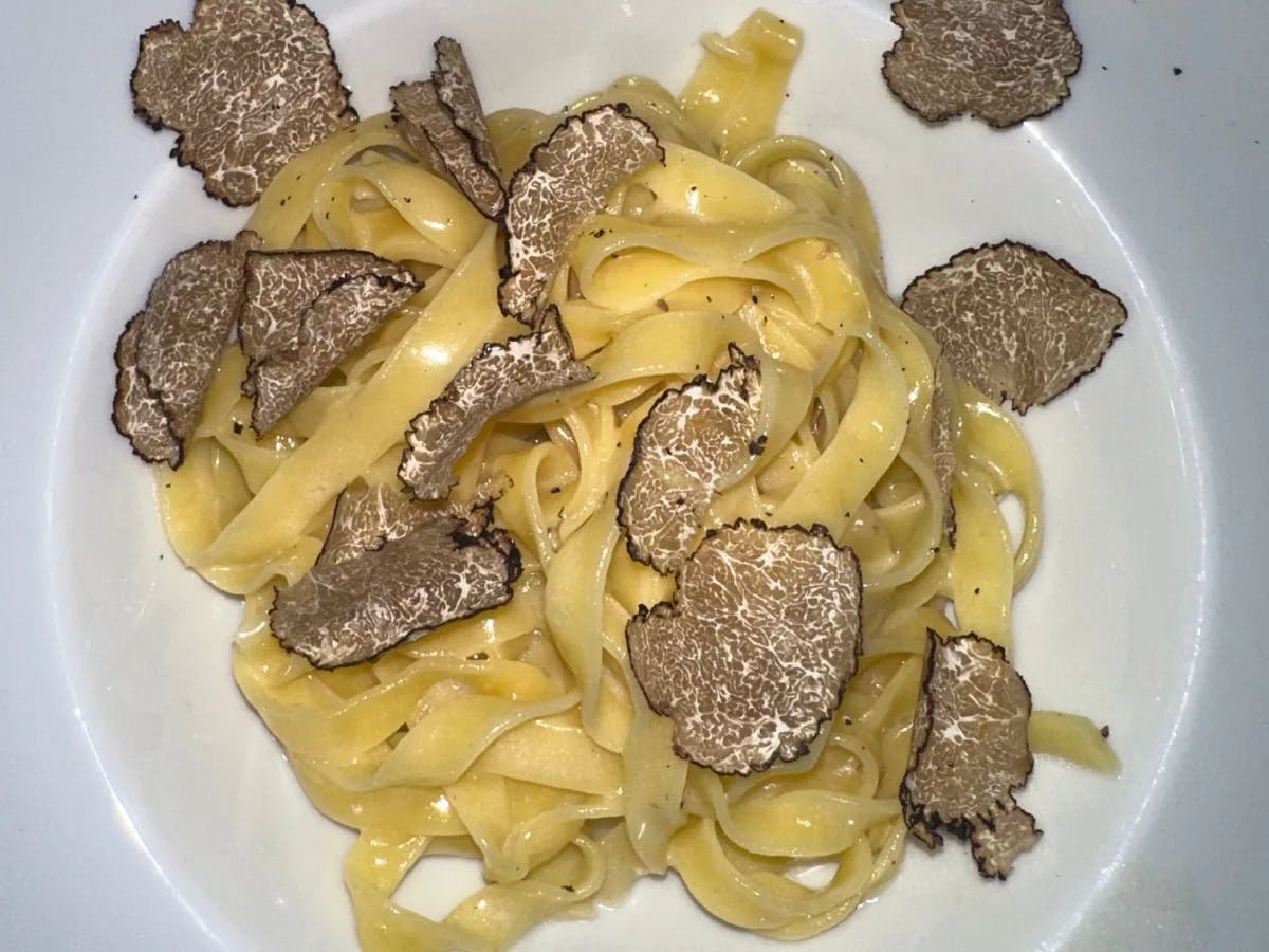 Pasta with meat in a white plate.