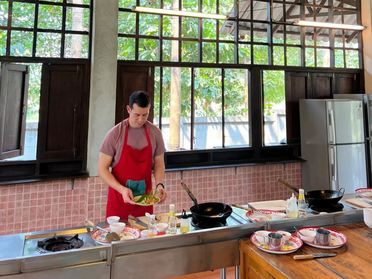 A person standing at a cooking station in a cooking class