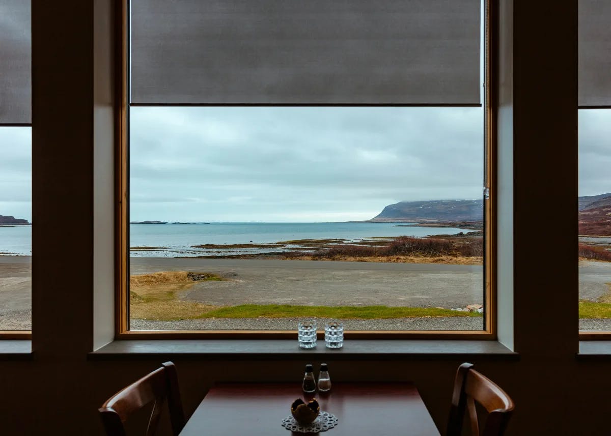 A table at a cafe looking out at an Iceland landscape.