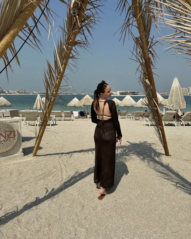 Picture of Georgia in black dress on beach