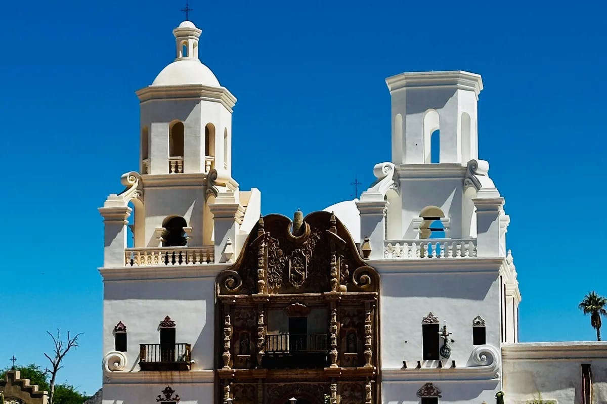 A large white and brown decorate building outside during the daytime