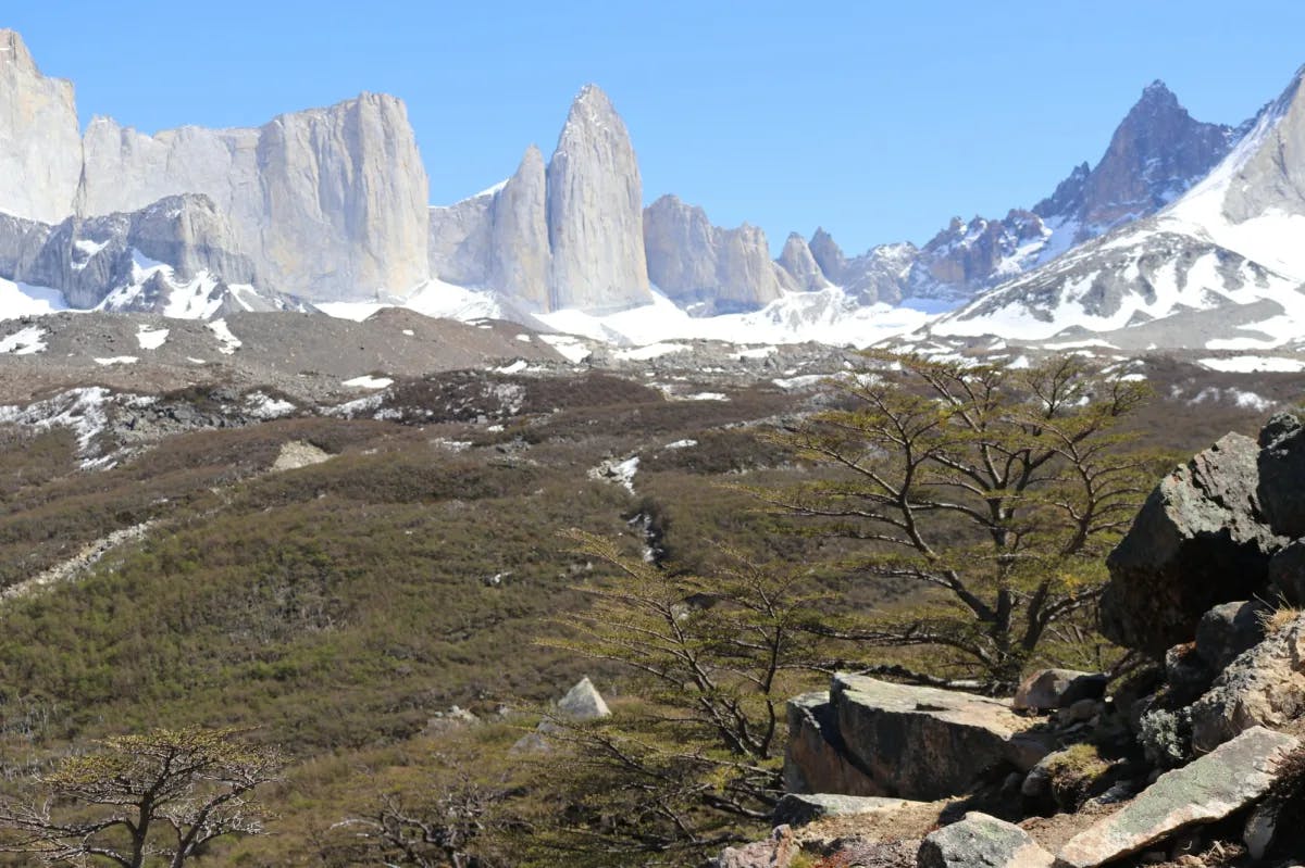 Rocky hills with snow at their foot.