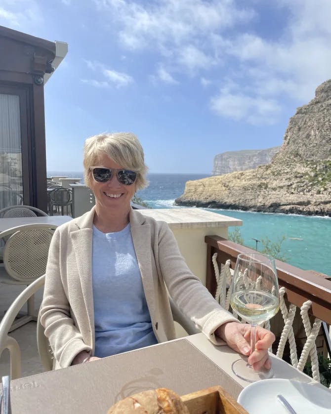 Travel advisor sitting in a restaurant beside the sea