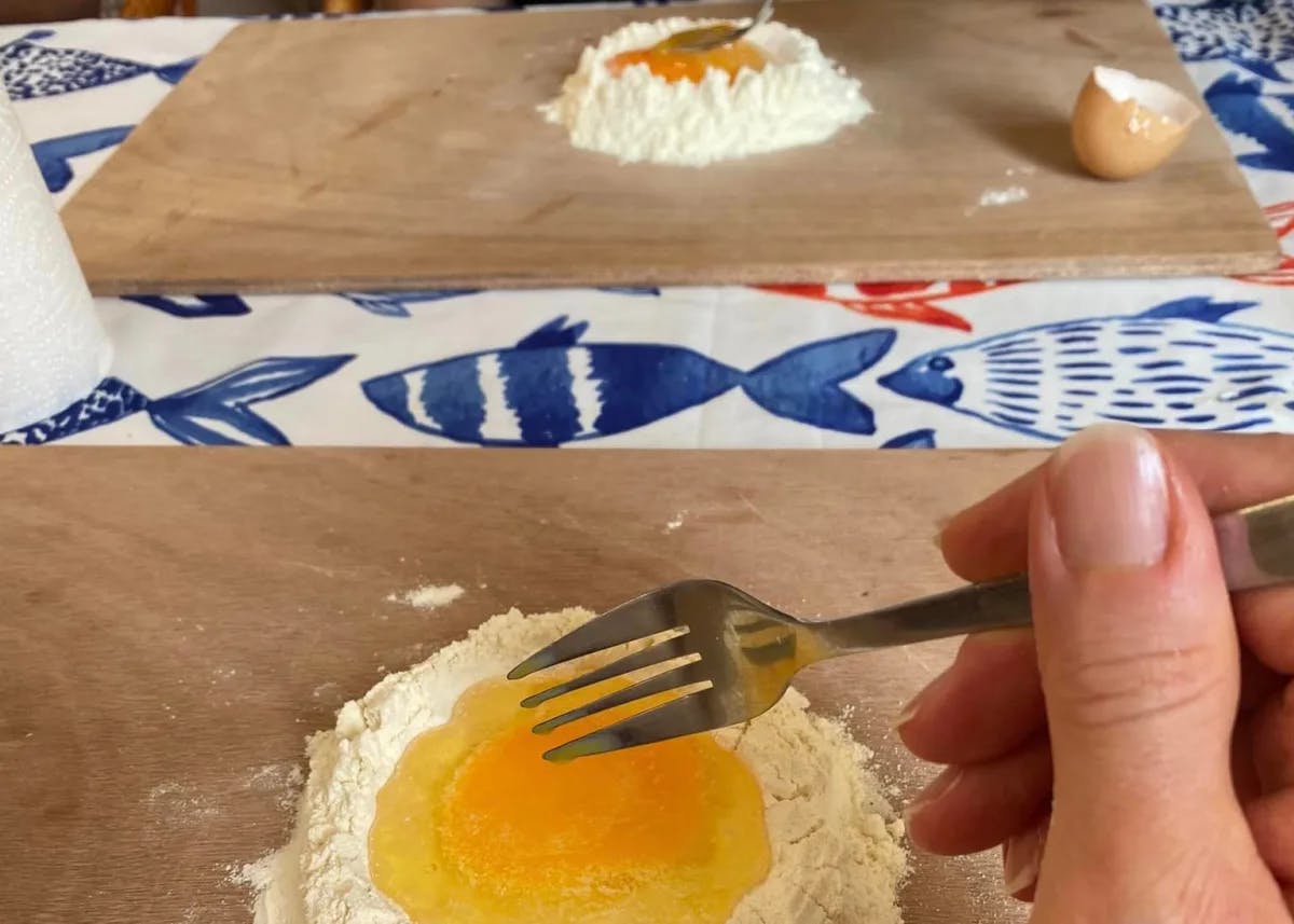 An aerial view of a pasta making class with flour and egg