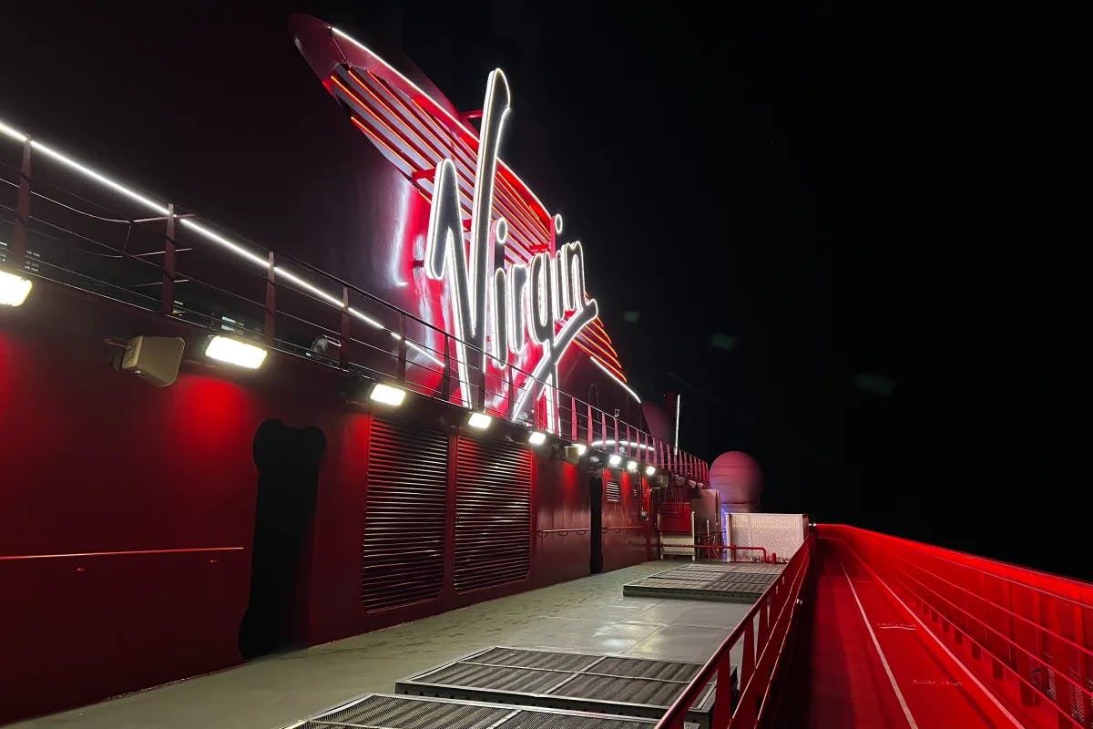 The red Virgin deck at nighttime with a large, lit-up "Virgin" sign.