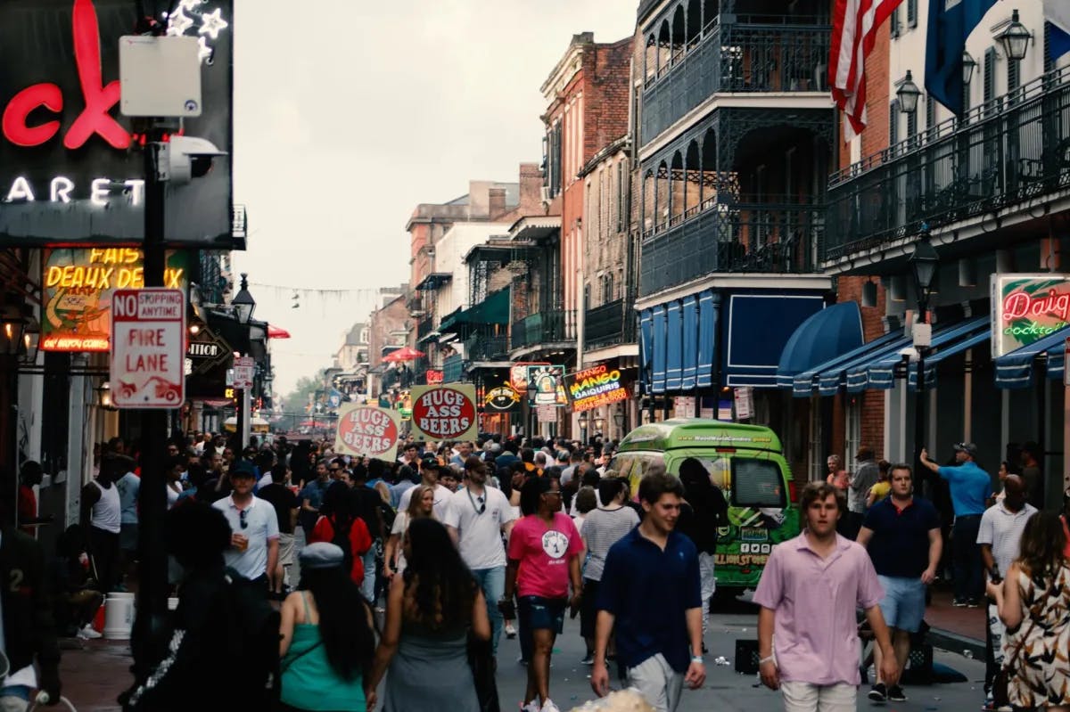 People Walking on Paved Road among city buildings.