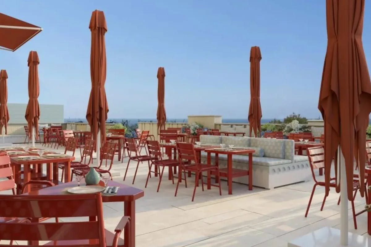 terrace with red furniture and closed red umbrellas