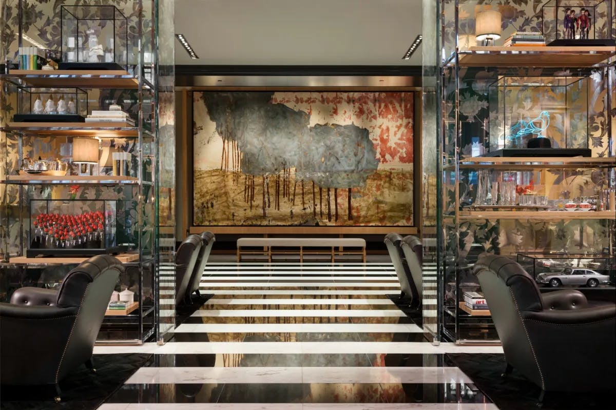 a fancy hotel lobby with a black-and-white striped floor and fancy glass shelves
