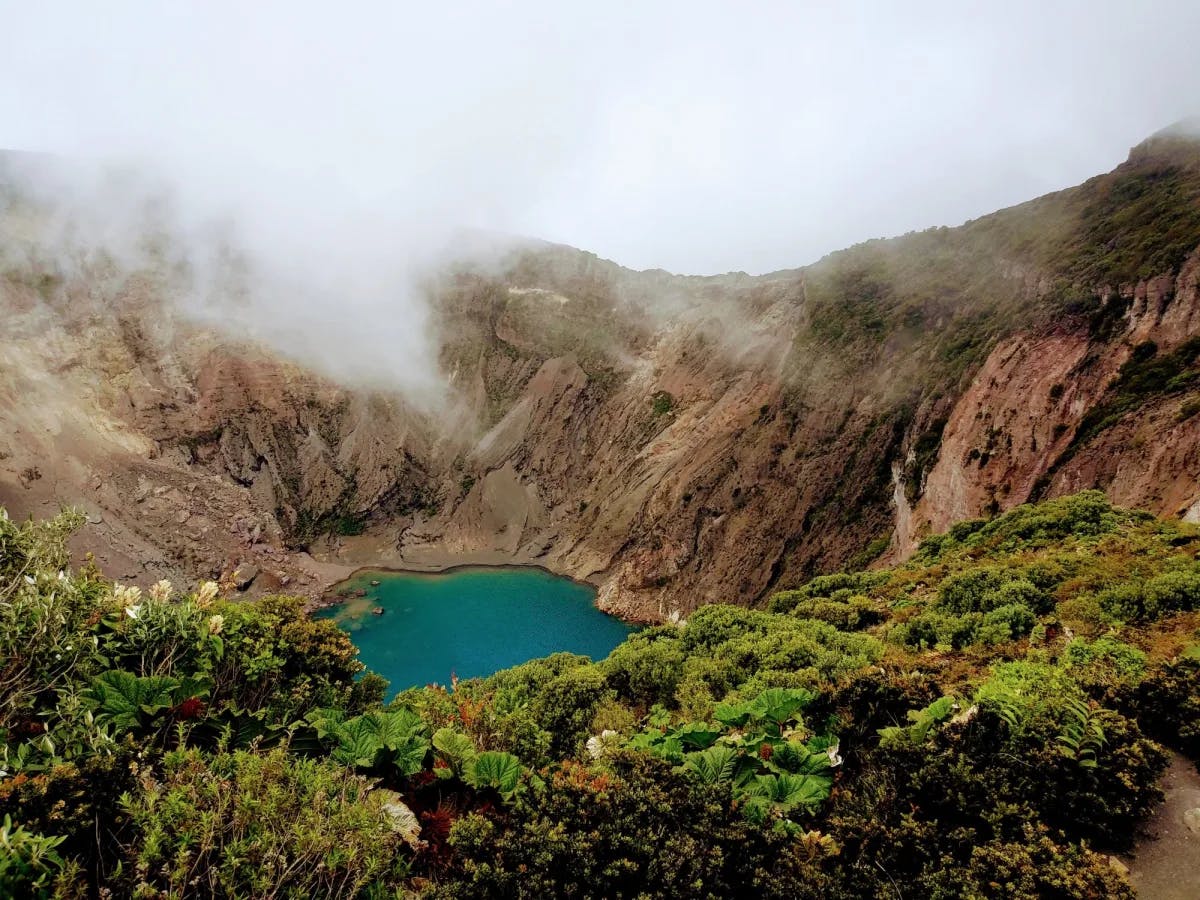 Little circular lake with mountains all around. 