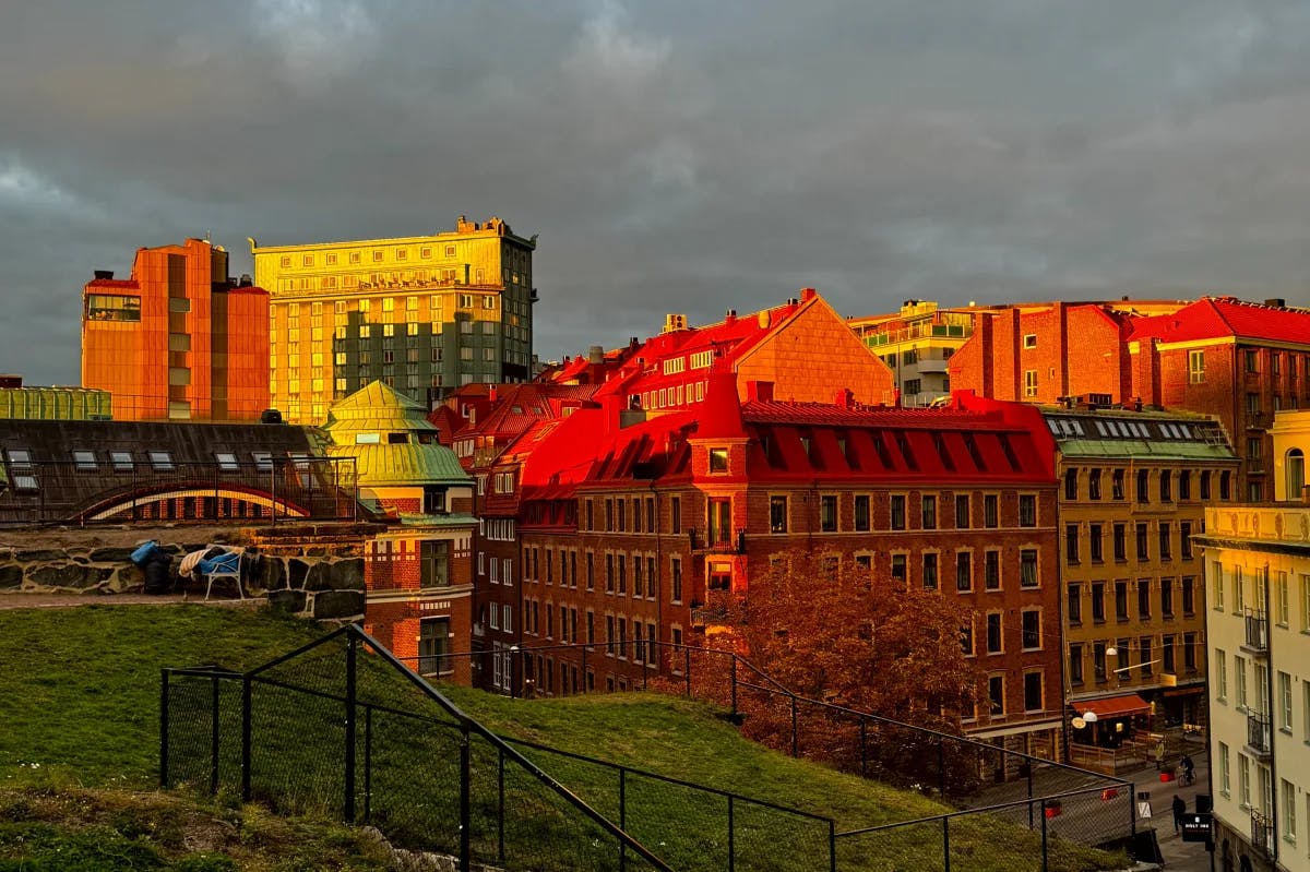 An aerial view of the multicolored buildings during sunrise.