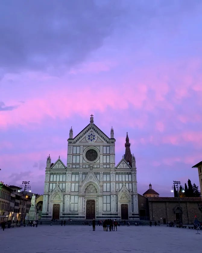 Picture of Basilica of Santa Croce in Florence with a gorgeous purple sunset and pink clouds 