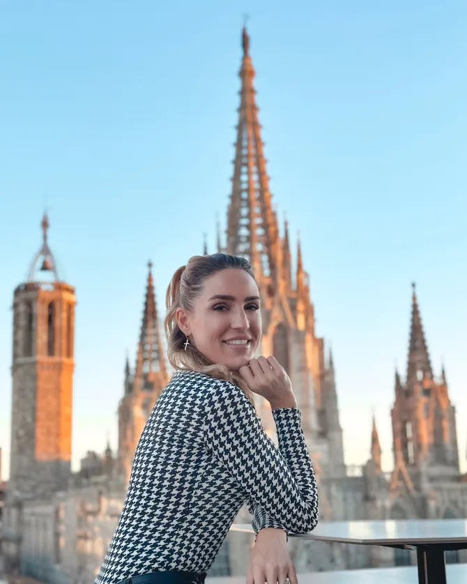 Amanda wearing a black and white top posing in front of a building in Spain