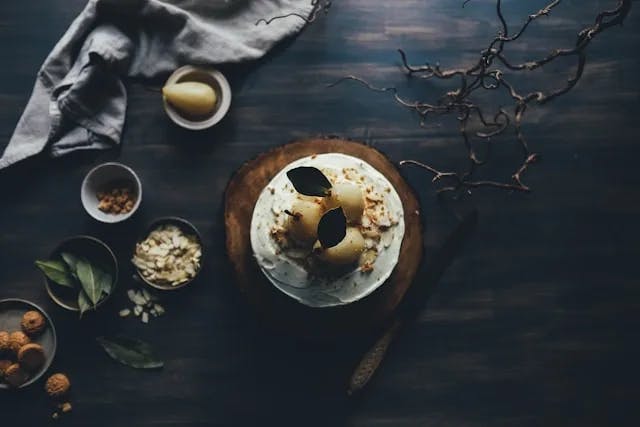 An aerial shot of food served on a dark wood table at a restaurant