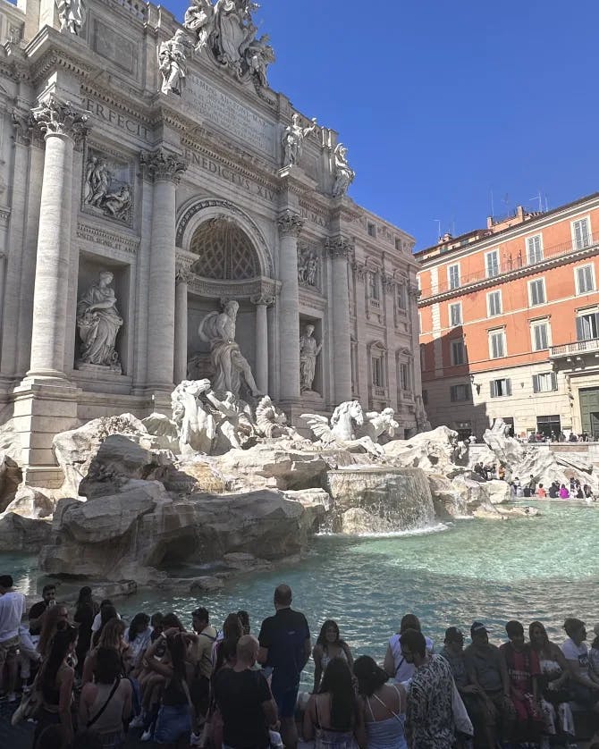 A large fountain in Rome on a sunny day.