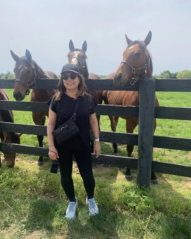 Travel advisor posing with horses