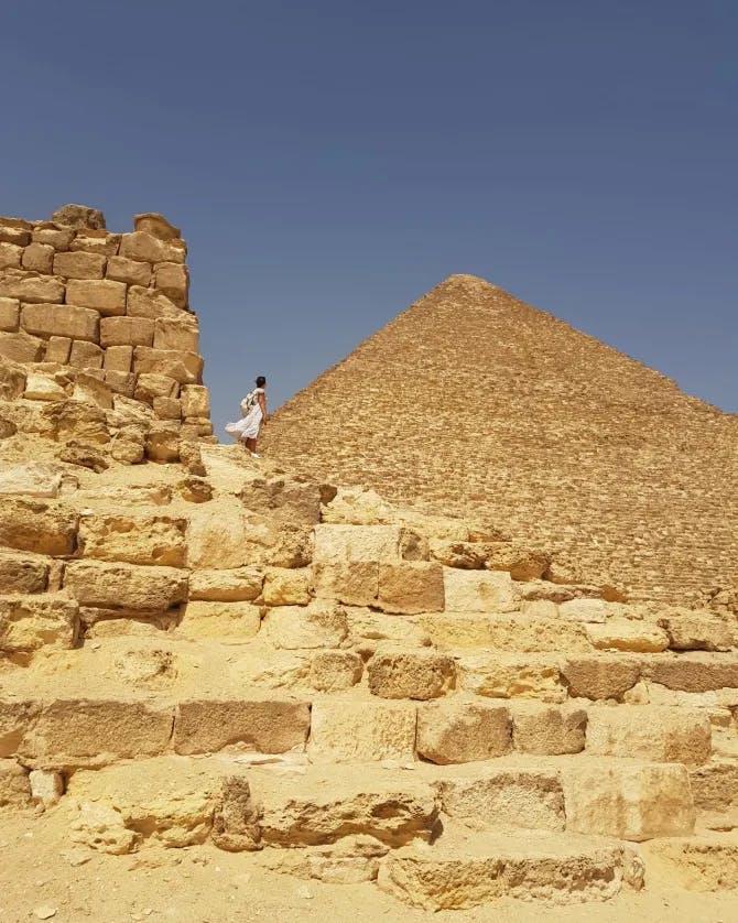 Travel advisor near a pyramid. 