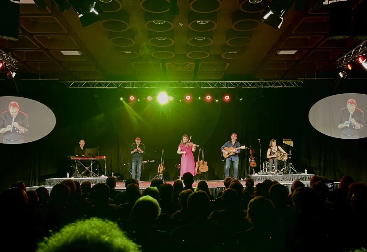 A musical band playing on a stage.