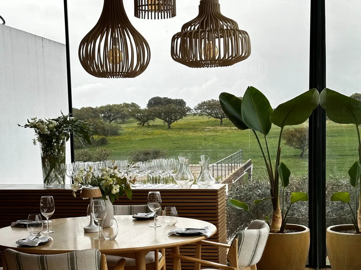 Outdoor sitting of a restaurant with a green field view. 