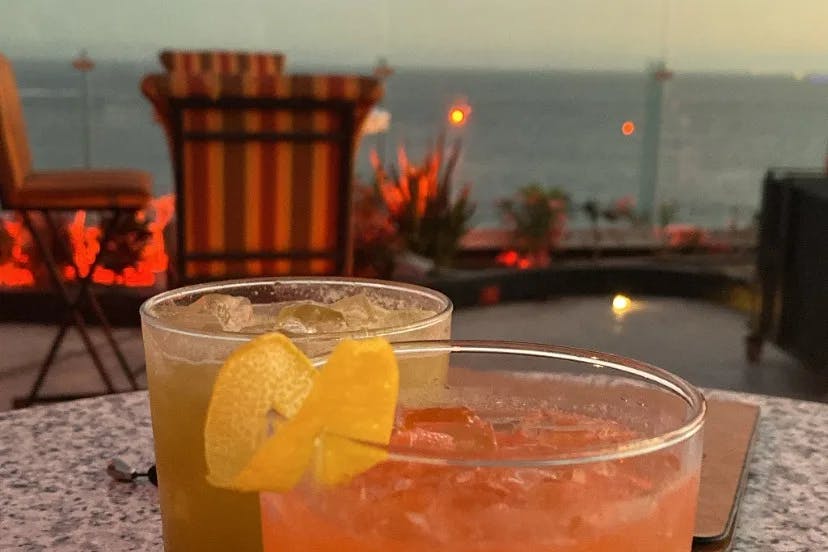 A picture of orange-colored drinks at sunset.