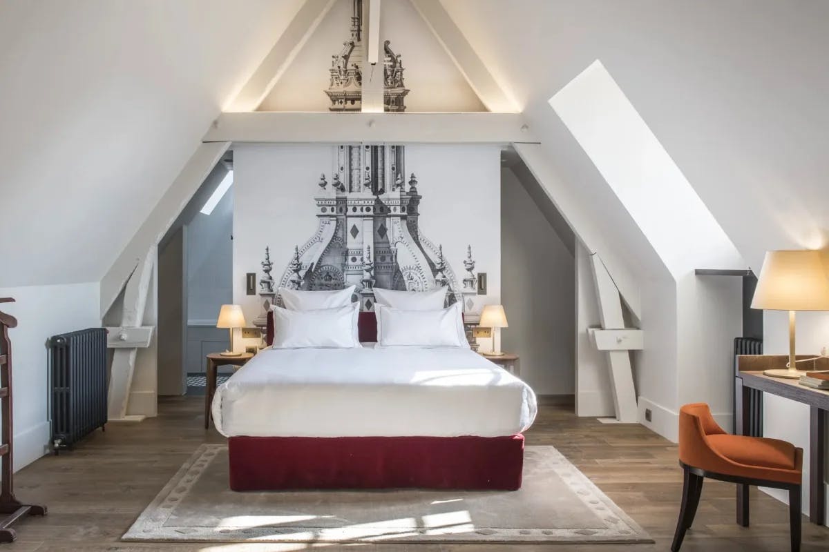 black and white bedrooms with peaked ceiling and a castle mural