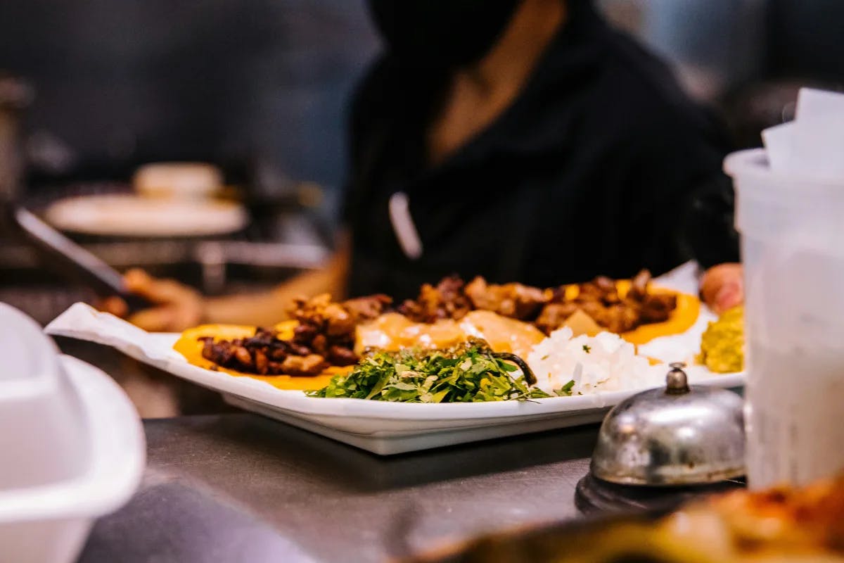 A plate of freshly prepared Mexican food, waiting to be served from the kitchen of a restaurant.